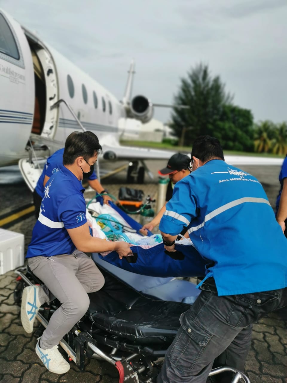 Ams Medical Team Transferring Patient To Air Ambulance Jet